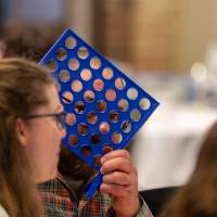 connect 4 game and people at table